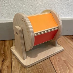 Great wooden baby toy. You spin it & there’s a ball inside that makes a noise.
